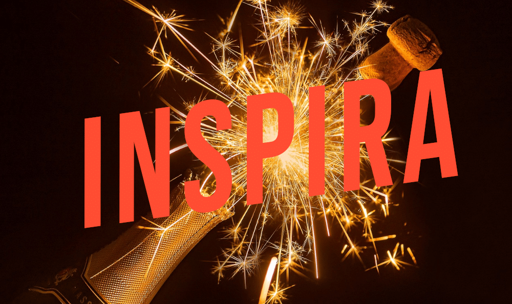 Inspira logo over champagne and fireworks