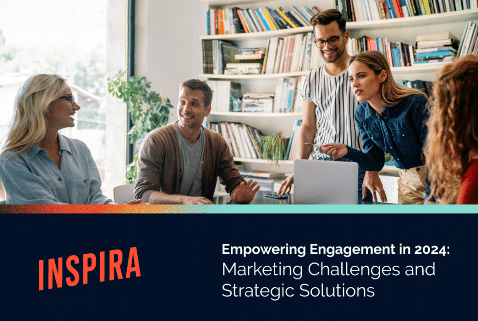 Smiling people working at a table. Text: "Inspira. Empowering Engagement 2024: Marketing Challenges and Strategic Solutions"